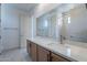 Bathroom featuring light wood cabinets, white countertops, and a large mirror reflecting the shower at 21430 W Meadowbrook Ave, Buckeye, AZ 85396