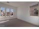 Bright bedroom with neutral carpet, large windows, and modern design elements at 21430 W Meadowbrook Ave, Buckeye, AZ 85396