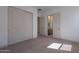 Bedroom with carpet, doors to closet and ensuite bath, and soothing color palette at 21430 W Meadowbrook Ave, Buckeye, AZ 85396