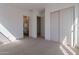 Spacious bedroom featuring plush carpeting, closet with sliding doors and ensuite bath at 21430 W Meadowbrook Ave, Buckeye, AZ 85396