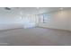 Spacious bonus room with neutral carpet, white walls, and bright window views of the desert landscape at 21430 W Meadowbrook Ave, Buckeye, AZ 85396