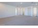 This spacious bonus room features neutral carpet, white walls and trim, and multiple doorways at 21430 W Meadowbrook Ave, Buckeye, AZ 85396