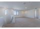 Upstairs bonus room with carpet, natural light, and neutral color palette at 21430 W Meadowbrook Ave, Buckeye, AZ 85396