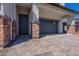 Inviting front entrance with stone accents, a gray door, and a paved walkway leading to the home at 21430 W Meadowbrook Ave, Buckeye, AZ 85396