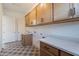 The laundry room features plentiful storage, countertop space and a lovely tiled floor at 21430 W Meadowbrook Ave, Buckeye, AZ 85396