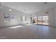 This expansive living room has tile flooring, recessed lighting, and large windows showcasing beautiful mountain views at 21430 W Meadowbrook Ave, Buckeye, AZ 85396