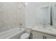 Bright bathroom featuring a shower, bathtub, modern vanity, and sleek quartz countertop offer a clean and luxurious design at 21450 W Meadowbrook Ave, Buckeye, AZ 85396