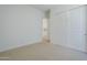 Inviting bedroom with neutral walls, closet, and carpeted floors provides a cozy and comfortable retreat at 21450 W Meadowbrook Ave, Buckeye, AZ 85396