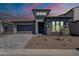 Charming single-Gathering home featuring modern architectural details, a two-car garage and desert landscaping at 21450 W Meadowbrook Ave, Buckeye, AZ 85396