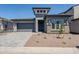 Charming single-Gathering home featuring modern architectural details, a two-car garage and desert landscaping at 21450 W Meadowbrook Ave, Buckeye, AZ 85396