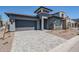 Stylish home with gray stucco, stone accents, two-car garage, and a well-maintained front yard at 21450 W Meadowbrook Ave, Buckeye, AZ 85396