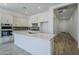Modern kitchen with white cabinets, stainless steel appliances, and a large center island at 21450 W Meadowbrook Ave, Buckeye, AZ 85396