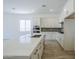 Modern kitchen showcasing white cabinets, stainless appliances, and a center island with a sink at 21450 W Meadowbrook Ave, Buckeye, AZ 85396