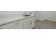 Laundry room with white cabinets, gray counter tops and stainless steel faucet at 21450 W Meadowbrook Ave, Buckeye, AZ 85396