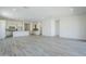 Spacious living area featuring light wood floors and an open layout leading into the kitchen area at 21450 W Meadowbrook Ave, Buckeye, AZ 85396