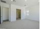 Spacious primary bedroom with carpet, recessed lighting and view to the bathroom at 21450 W Meadowbrook Ave, Buckeye, AZ 85396