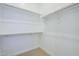 Well-organized walk-in closet with adjustable shelving and hanging rods, offering ample storage for a neat and tidy space at 21450 W Meadowbrook Ave, Buckeye, AZ 85396