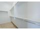 Spacious walk-in closet boasts ample storage space with shelving and hanging rods, perfect for organization at 21450 W Meadowbrook Ave, Buckeye, AZ 85396