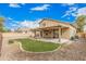 A gravel backyard with a cozy covered patio, small green lawn area, and mature landscaping at 22337 E Via Del Palo --, Queen Creek, AZ 85142