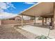 A covered patio and gravel in this backyard provides low-maintenance landscaping with privacy from a block wall at 22337 E Via Del Palo --, Queen Creek, AZ 85142