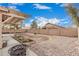 Spacious backyard with gravel, planting beds, block wall, covered patio, and an outdoor fire pit for entertaining at 22337 E Via Del Palo --, Queen Creek, AZ 85142