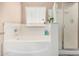 Bright bathroom featuring soaking tub with window and glass-enclosed shower at 22337 E Via Del Palo --, Queen Creek, AZ 85142