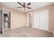 Empty bedroom featuring a ceiling fan, carpet flooring, and a double door closet at 22337 E Via Del Palo --, Queen Creek, AZ 85142