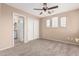 Empty bedroom featuring a ceiling fan, carpet flooring, and a double door closet at 22337 E Via Del Palo --, Queen Creek, AZ 85142