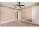 Cozy bedroom with wood-look floors, ceiling fan with lights, and white doors and trim at 22337 E Via Del Palo --, Queen Creek, AZ 85142