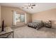 Spacious bedroom with a ceiling fan, large window, and neutral colored walls at 22337 E Via Del Palo --, Queen Creek, AZ 85142