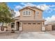 Inviting two-story home featuring a well-manicured front yard and a spacious two-car garage at 22337 E Via Del Palo --, Queen Creek, AZ 85142