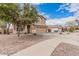 Charming home with well-kept landscaping, a spacious driveway, and a two-car garage at 22337 E Via Del Palo --, Queen Creek, AZ 85142