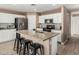 Bright kitchen island with granite countertops and seating, featuring stainless steel appliances at 22337 E Via Del Palo --, Queen Creek, AZ 85142
