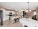 Open kitchen and dining area, featuring granite countertops and stainless steel appliances at 22337 E Via Del Palo --, Queen Creek, AZ 85142