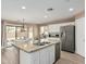 Spacious kitchen with a large island, granite countertops, and stainless steel appliances at 22337 E Via Del Palo --, Queen Creek, AZ 85142