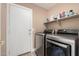 Laundry room with shelving, utility sink and modern appliances at 22337 E Via Del Palo --, Queen Creek, AZ 85142
