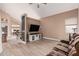 Comfortable living area features wood-look flooring, a mounted TV, and a soft brown sofa at 22337 E Via Del Palo --, Queen Creek, AZ 85142