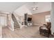 Open-concept living area featuring wood floors, a ceiling fan, and a staircase to the second floor at 22337 E Via Del Palo --, Queen Creek, AZ 85142