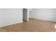 Spacious room with wood-look tile flooring, white walls, and access to a closet at 2823 W Eagle Talon Rd, Phoenix, AZ 85085