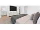 Well-lit bedroom with a TV, a dresser, and access to an ensuite bathroom at 2823 W Eagle Talon Rd, Phoenix, AZ 85085