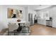 Modern kitchen with stainless steel appliances, white cabinets, and a dining area at 2823 W Eagle Talon Rd, Phoenix, AZ 85085