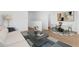Cozy living room adjacent to a dining area and featuring hardwood floors at 2823 W Eagle Talon Rd, Phoenix, AZ 85085