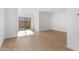 Bright living room with wood-look flooring, sliding glass door to the patio at 2823 W Eagle Talon Rd, Phoenix, AZ 85085