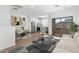 Open-concept living room with a dining area, kitchen, and sliding glass doors to the exterior at 2823 W Eagle Talon Rd, Phoenix, AZ 85085