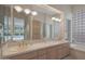 Bathroom featuring double sink, glass block window, and soaking tub at 3120 E Squaw Peak Cir, Phoenix, AZ 85016