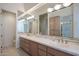 Spacious bathroom with dual sinks, wood cabinets, and large mirrors at 3120 E Squaw Peak Cir, Phoenix, AZ 85016