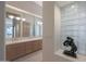 Bathroom featuring a double vanity, glass block window, and neutral tile at 3120 E Squaw Peak Cir, Phoenix, AZ 85016