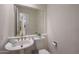 Chic powder room with pedestal sink, modern fixtures, and decorative touches for a stylish guest experience at 3120 E Squaw Peak Cir, Phoenix, AZ 85016