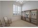 Bright bedroom with shutters, a ceiling fan, and built-in display shelving at 3120 E Squaw Peak Cir, Phoenix, AZ 85016