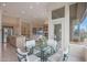 Bright breakfast nook with glass table and chairs, adjacent to the kitchen, overlooking the backyard at 3120 E Squaw Peak Cir, Phoenix, AZ 85016